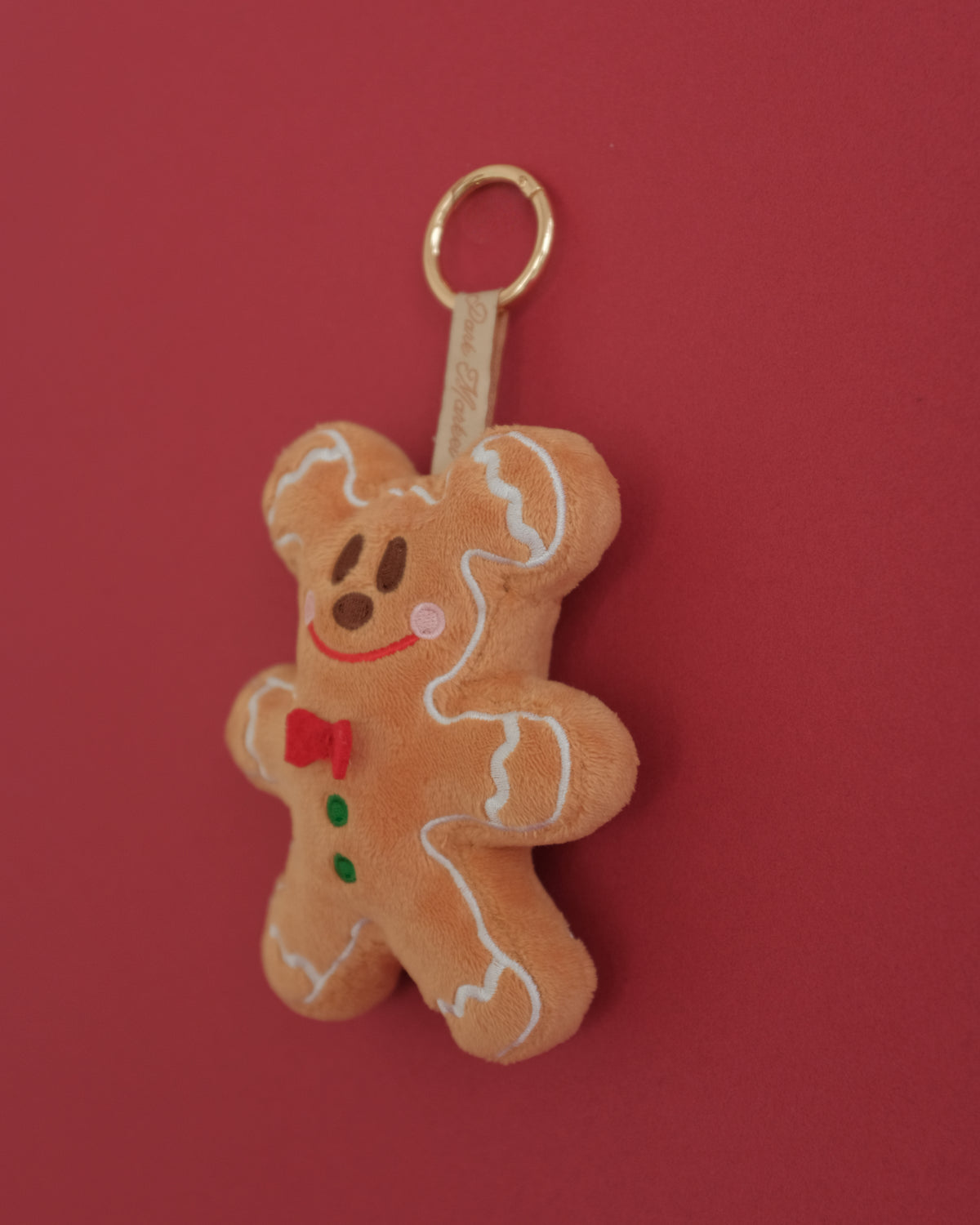 Gingerbread Gent bag charm from the side, showing its plush cookie shape