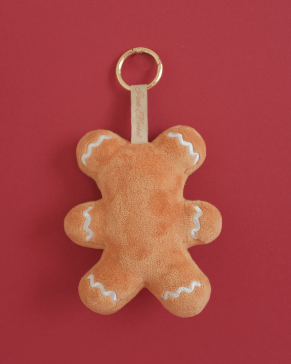 Back of the Gingerbread Gent bag charm with frosting waves on the arms, legs and ears
