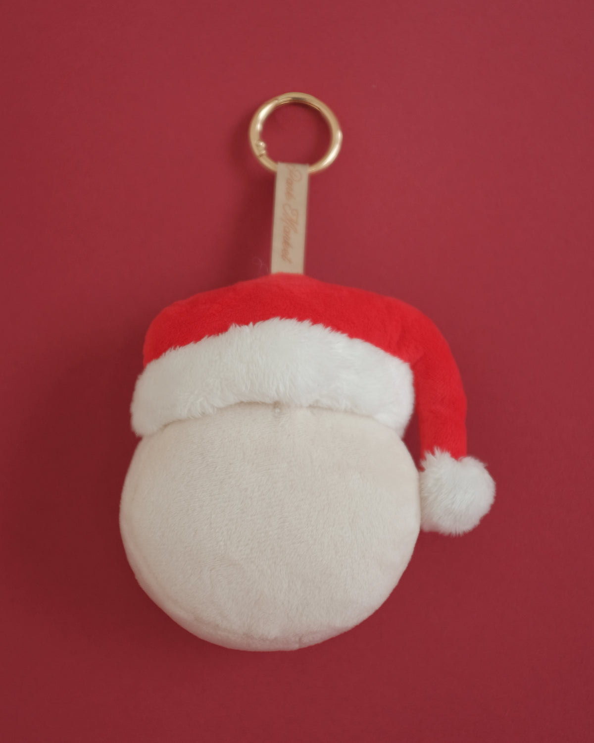 Back of the Tinsel Time bag charm: a plain plush face under the fur-trimmed Santa hat