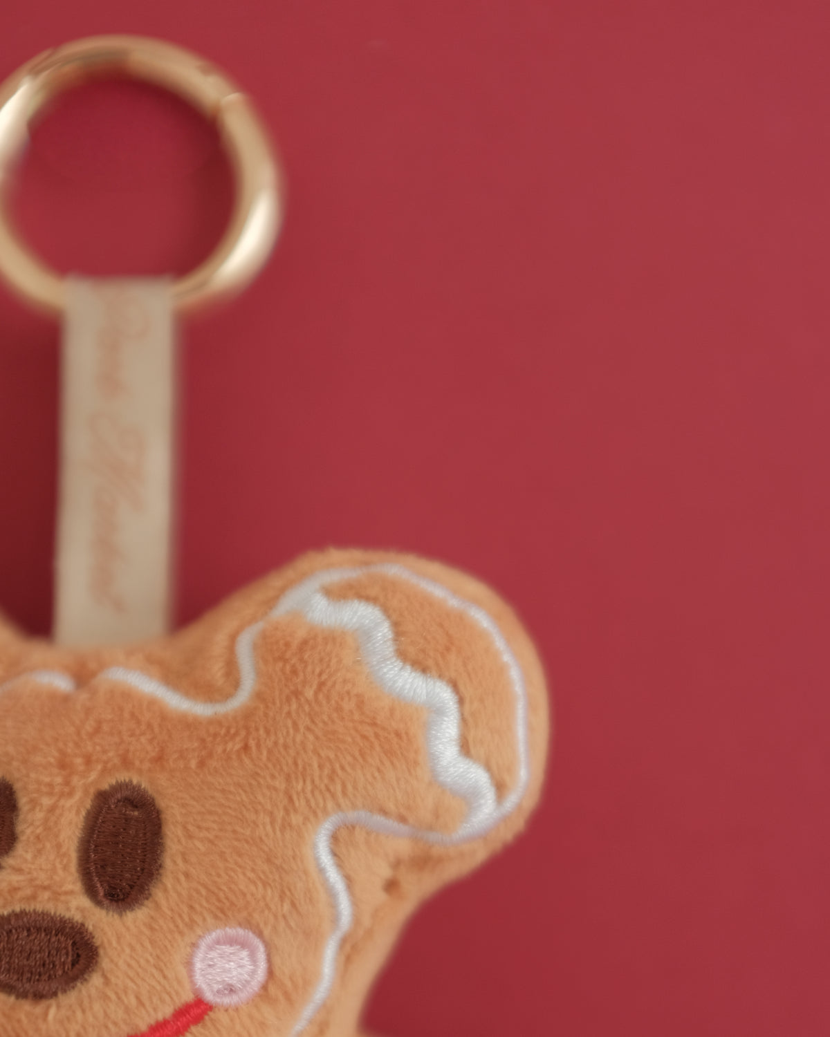 Close-up of Gingerbread Gent's frosting embroidery and the Park Market hang tag