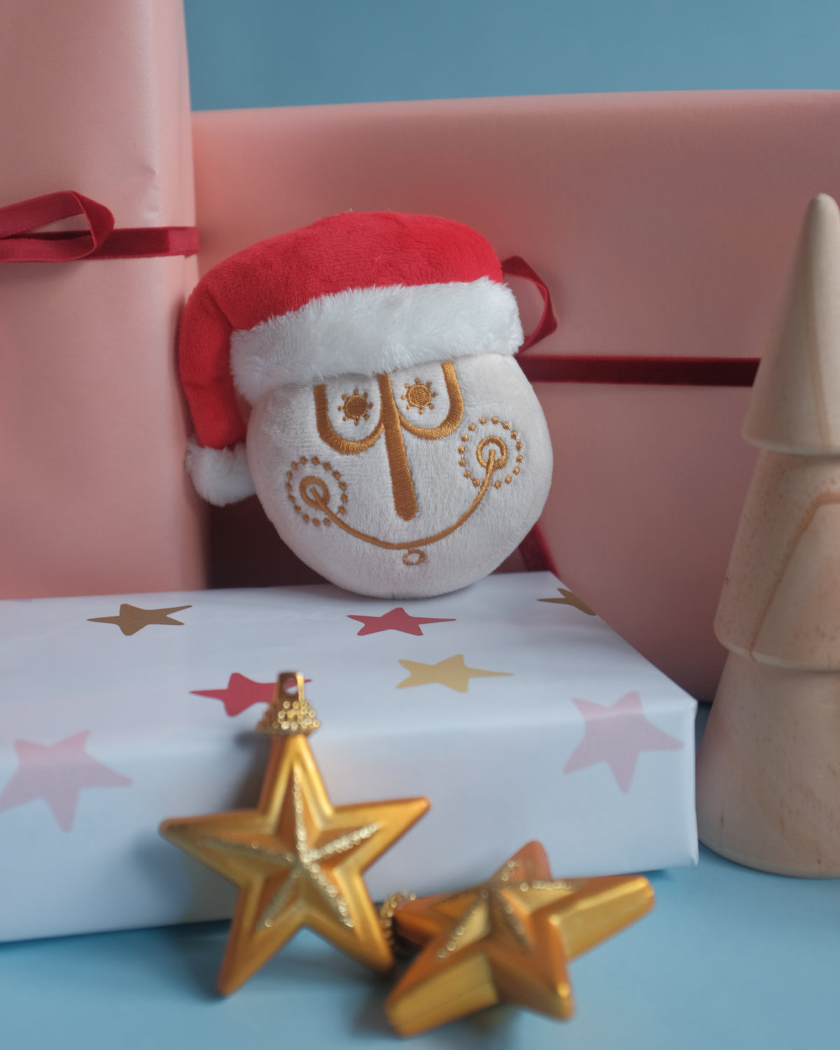 Tinsel Time bag charm on star-print gift wrap with gold star ornaments