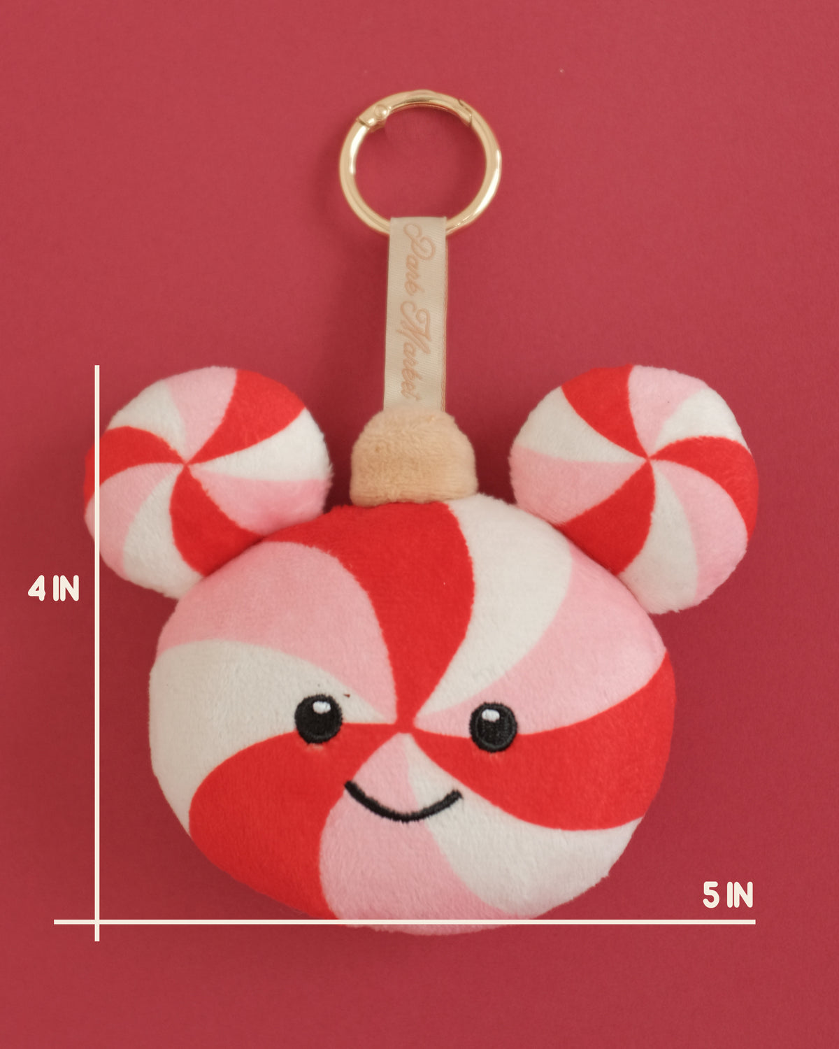 Peppermint swirl plush bag charm with a smiling face; measurement lines show 4 inches tall by 5 inches wide