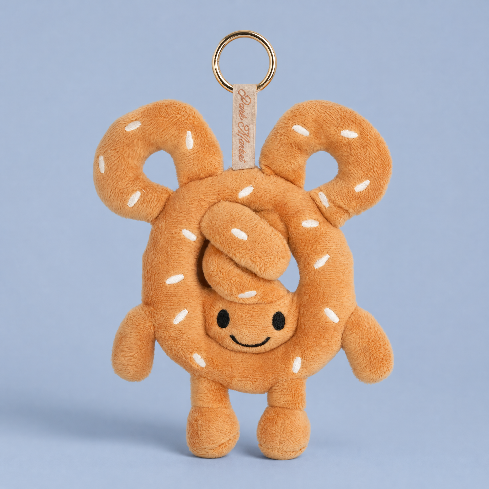 Hand-sewn soft pretzel plush bag charm, golden brown with salted texture